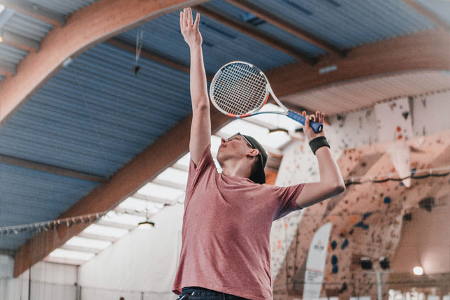 Man playing tennis in a sports hall